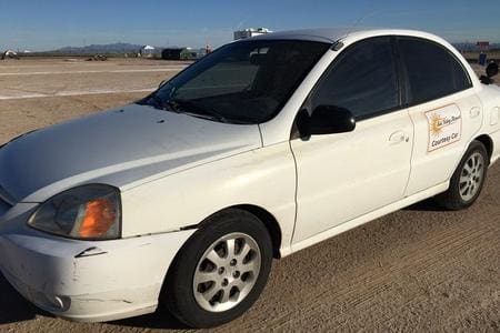 A white car parked on the side of a road.
