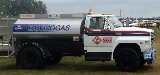 A truck with mogas on the side of it.